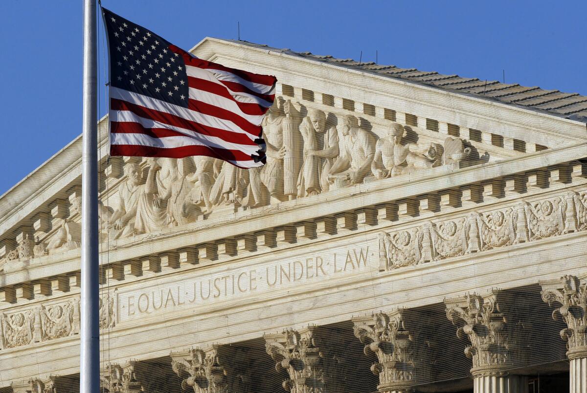 A U.S. flag flies in front of the Supreme Court in Washington.