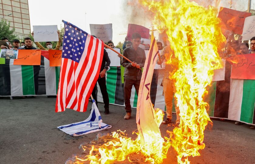 Iranian students from the Islamic Basij volunteer militia burn US and Israeli flags in the capital Tehran, on July 16.