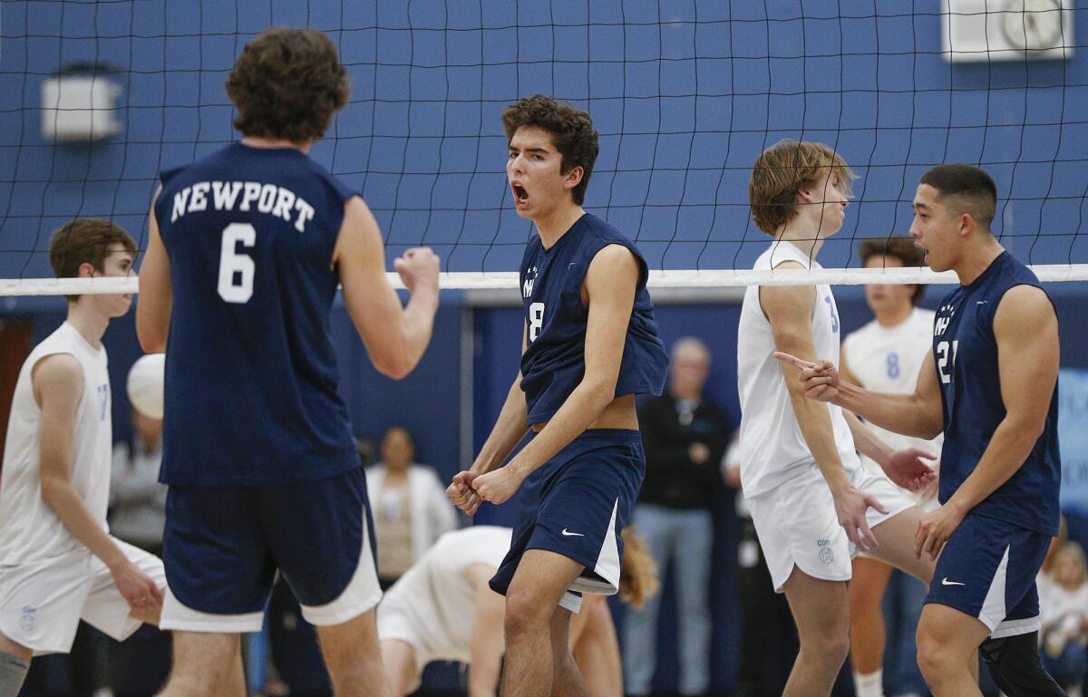 Newport Harbor's Lukas Johnson (8) reacts to a block for a point with teammate Jake Read (6) against Corona del Mar.