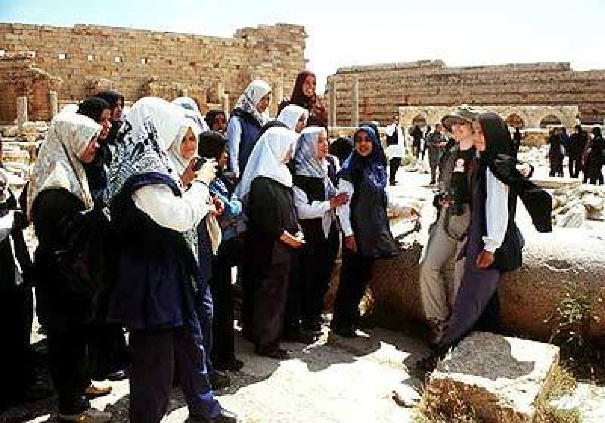 Libyan schoolgirls with a Western tourist at Leptis Magna ruin, included on many cruise itineraries.