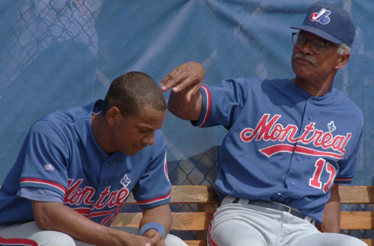 Montreal Expos manager Felipe Alou speaks with his son, Moises