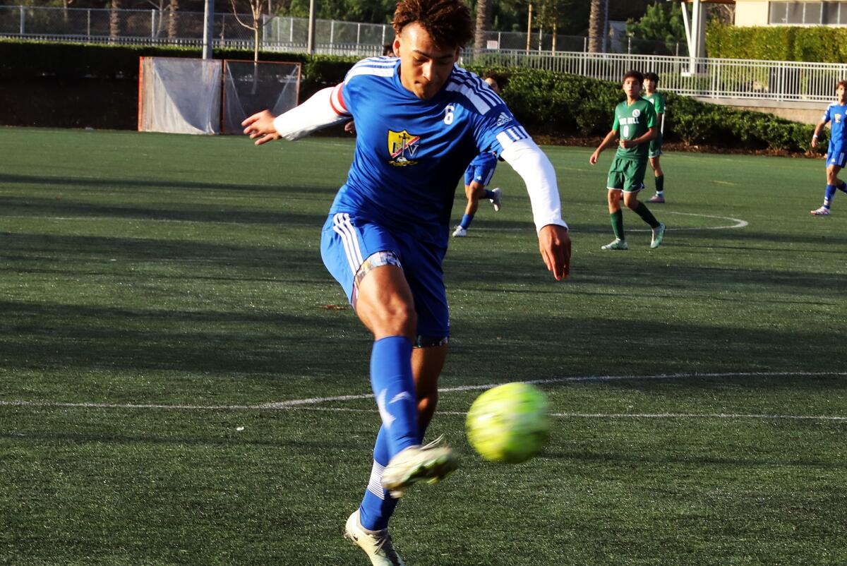 Fountain Valley's Micah Yanez (6) kicks toward the goal against Sage Hill.