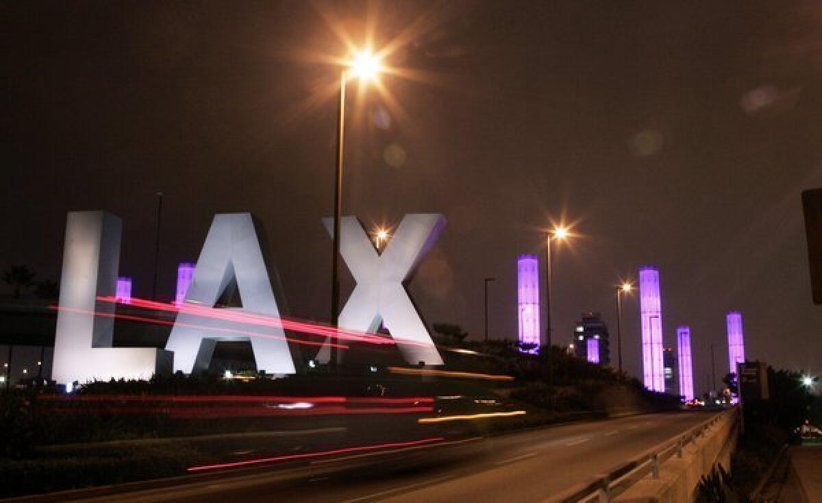 Ferazzi, Gina ¿¿ ¿ 115264.ME.0913.pylons.2.GMF¿The colorful pylons have been illuminated again at the entrance to LAX, Sept. 13, 2006.(Gina Ferazzi/Los Angeles Times)
