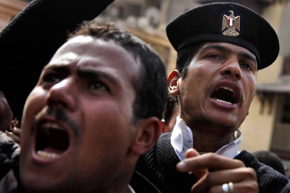 Egyptian police officers demonstrate in front of the Interior Ministry. The revolution that toppled President Hosni Mubarak "has changed the system. We’re confused about who we are now," said one officer.