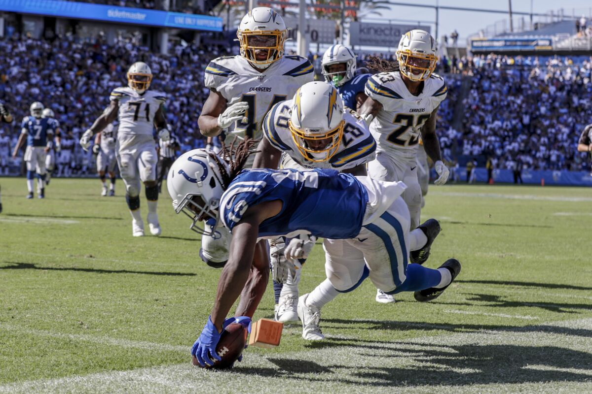 Indianapolis Colts receiver TY Hilton dives for a touchdown past Chargers defenders late in the fourth quarter at Dignity Health Sports Park on Sunday.