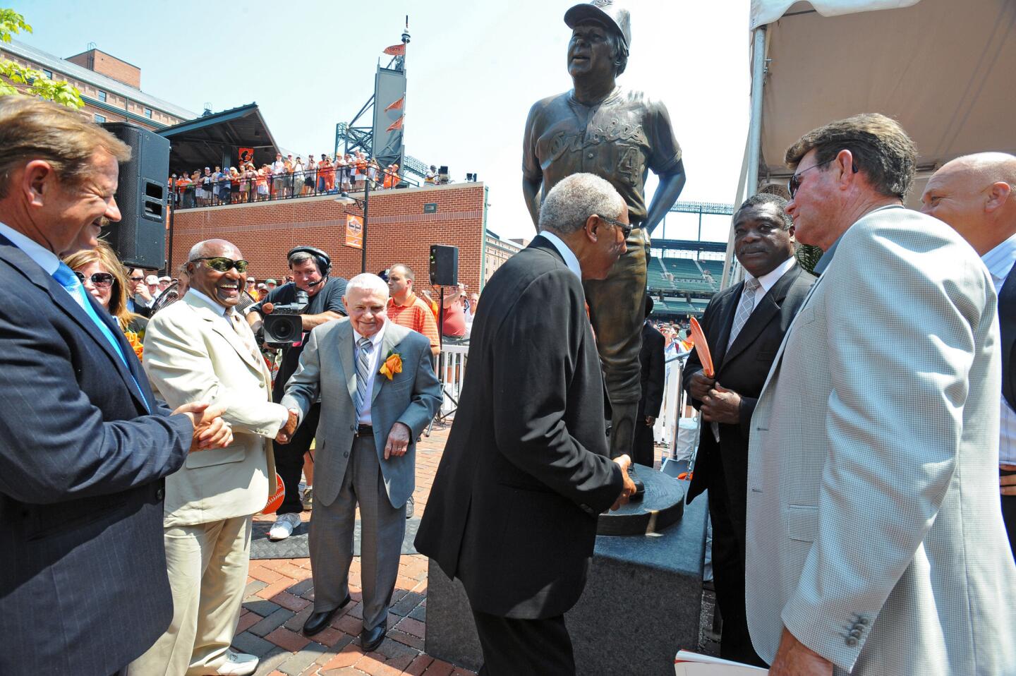 Former Orioles manager Earl Weaver, third from left, joins former Orioles players (l-r) Rick Dempsey, Don Buford, Frank Robinson, Eddie Murray, Jim Palmer and Cal Ripken Jr., after the unveiling of his statue at the center-field Legends' Garden of Oriole Park at Camden Yards on Saturday.