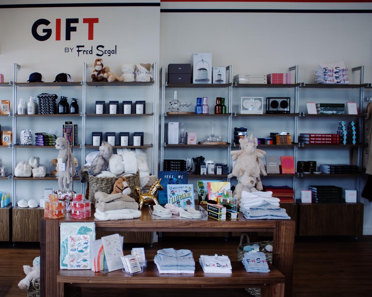 An array of merchandise on shelves, with the words "Gift by Fred Segal" on the wall.