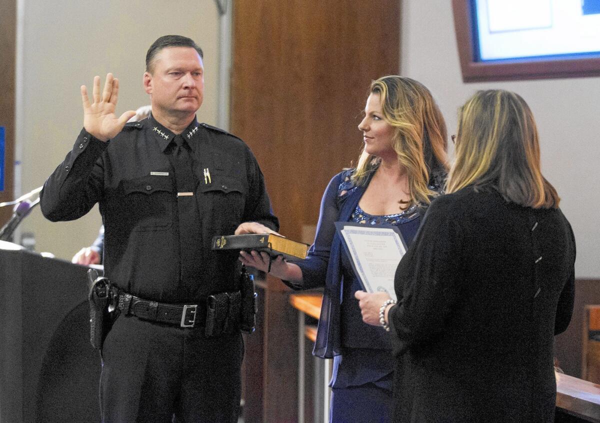Rob Sharpnack with wife, Stephanie, center, during a July 1, 2015, swearing-in ceremony at Costa Mesa City Hall