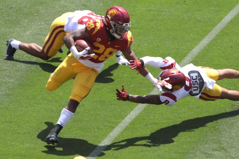 Running back Keaontay Ingram carries the ball past defensive back Chris Steele (8) during the USC spring game April 17, 2021.