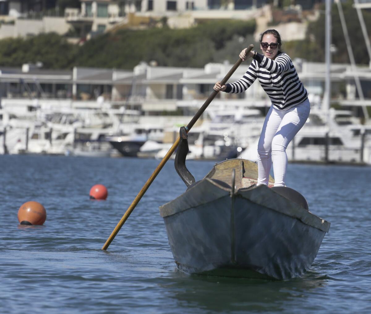 Roselyn Young maneuvers her gondola around a buoy during the solo obstacle event Saturday at the U.S. Gondola Nationals being held this weekend at the Bahia Corinthian Yacht Club in Newport Beach.