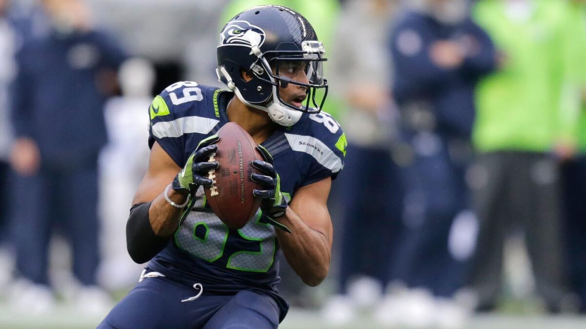 Seattle receiver Doug Baldwin gets set to pass to quarterback Russell Wilson against Philadelphia on Sunday.