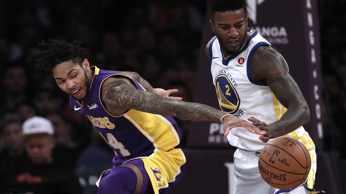 The Lakers' Brandon Ingram, left, and the Warriors' Jordan Bell vie for a loose ball.