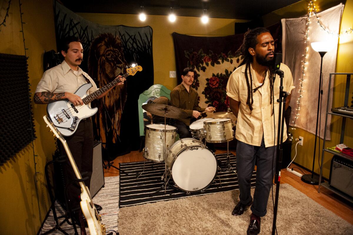 The group practices at Alex Garcia’s home studio in Chula Vista, decorated with various blankets, rugs and light fixtures.
