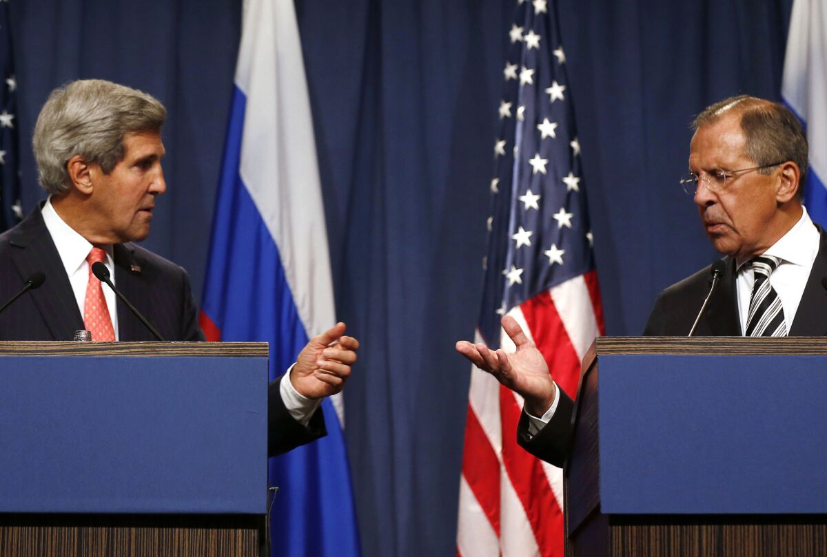 Secretary of State John Kerry, left, holds a joint press conference with Russian Foreign Minister Sergei Lavrov in Geneva after they met for talks on Syria's chemical weapons.