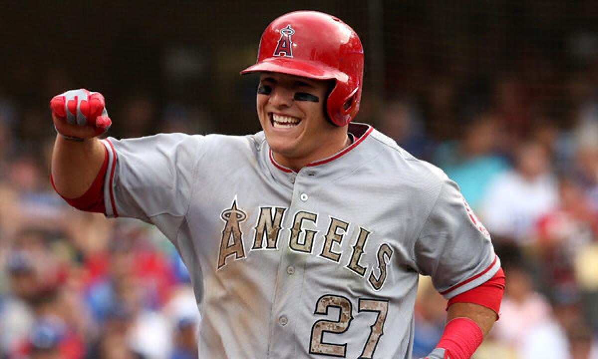 Angels outfielder Mike Trout celebrates after scoring a run against the Dodgers in May. Trout and the Angels could agree to a new contract before the start of the regular season.