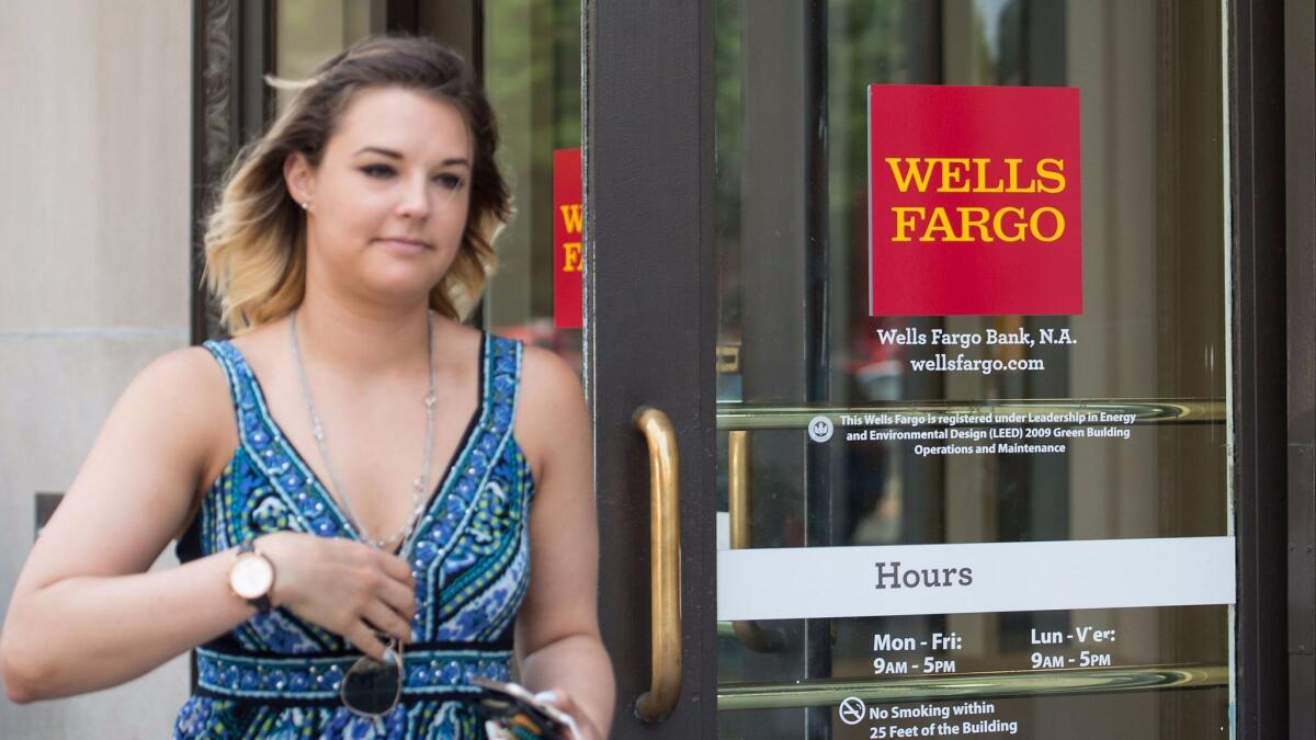 A woman walks out of a Wells Fargo bank in Washington, D.C., on May 27, 2016.