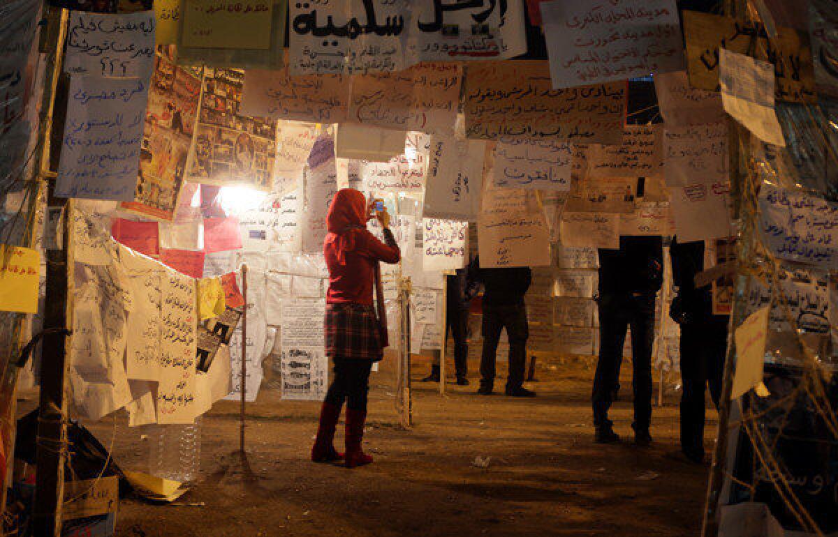 A woman visits an installation of political slogans in Cairo's Tahrir Square on Saturday.