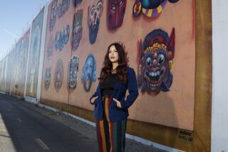 Michelle Ruby Guerrero, also known as Mrbbaby, stands in front of one of her favorite murals she painted  in Chula Vista.