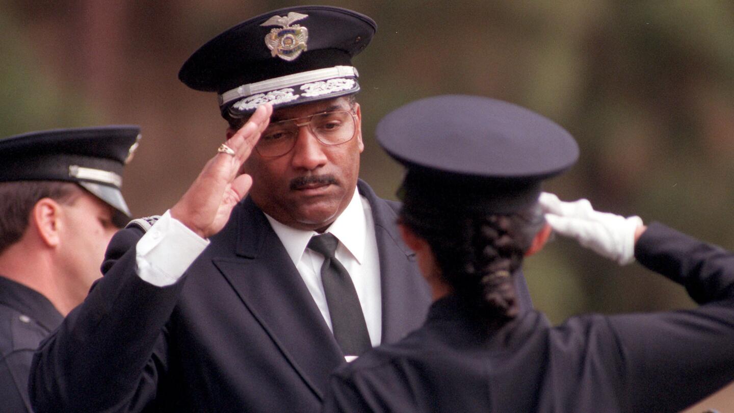 Los Angeles Police Chief Willie L. Williams salutes a newly graduated recruit at a ceremony at the LAPD Academy in 1995.