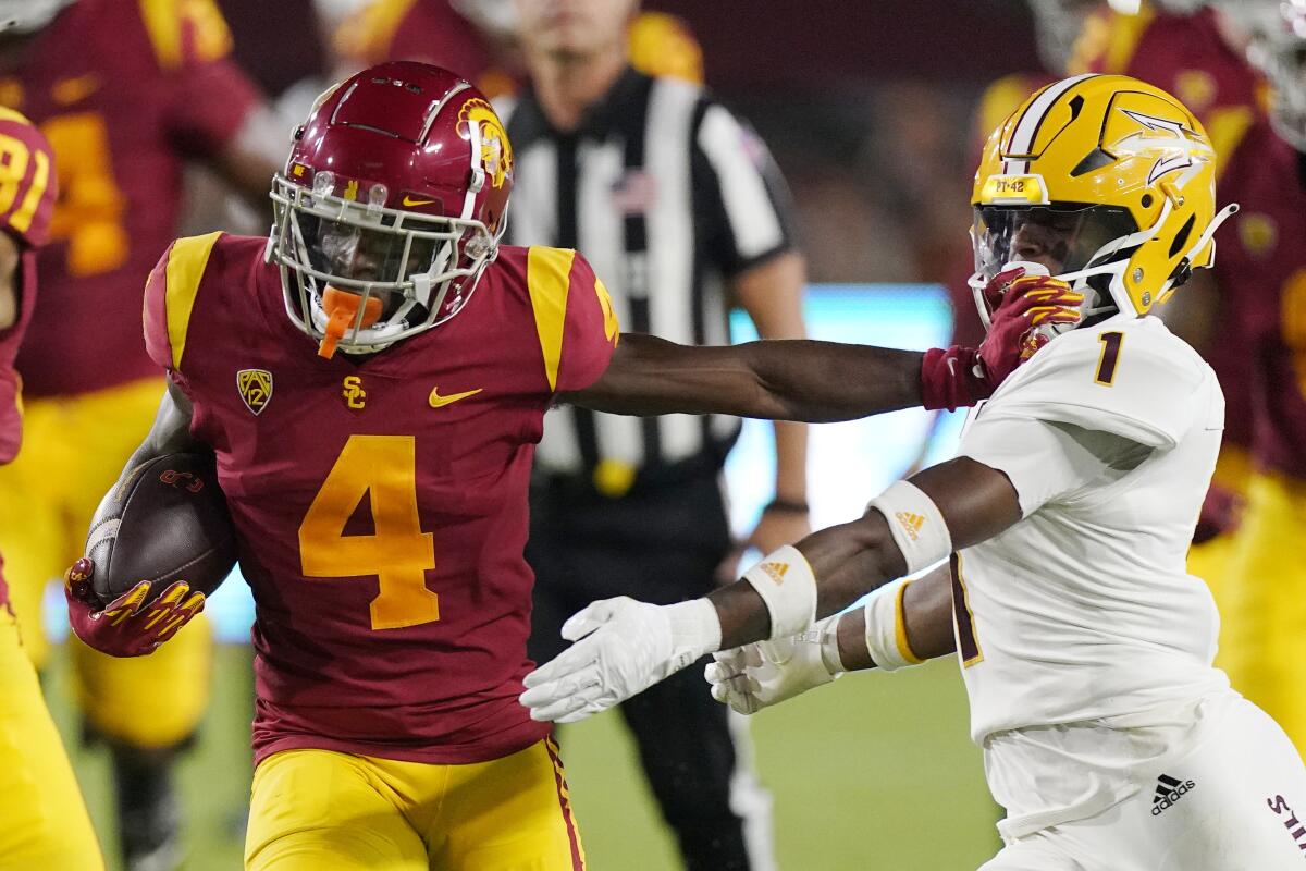 USC wide receiver Mario Williams, left, stiff arms Arizona State defensive back Jordan Clark during a Trojans win on Oct. 1.