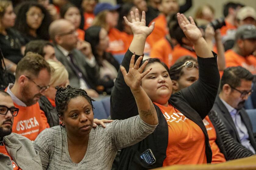LOS ANGELES, CA FEBRUARY 12, 2019 --- Community activists Patrisse Cullors, left, and Eunisses Hernandezof applaud a speaker during a debate for vote by L.A. County Supervisors to approve a $215 million budget for a new controversial women?s jail project. The $215-million proposal to renovate Mira Loma Detention Center, an out-of-use detention facility in the high-desert city of Lancaster which once housed immigrants who were in the U.S. illegally, has gone through several rounds of approvals since it was launched under prior leadership in 2013 to address jail overcrowding. (Irfan Khan / Los Angeles Times)