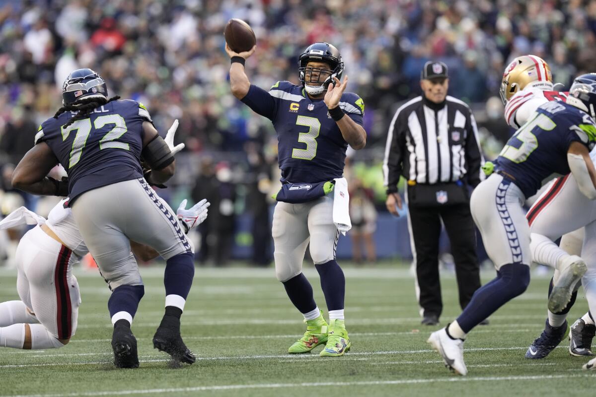 Seattle Seahawks quarterback Russell Wilson throws a touchdown pass against the San Francisco 49ers.