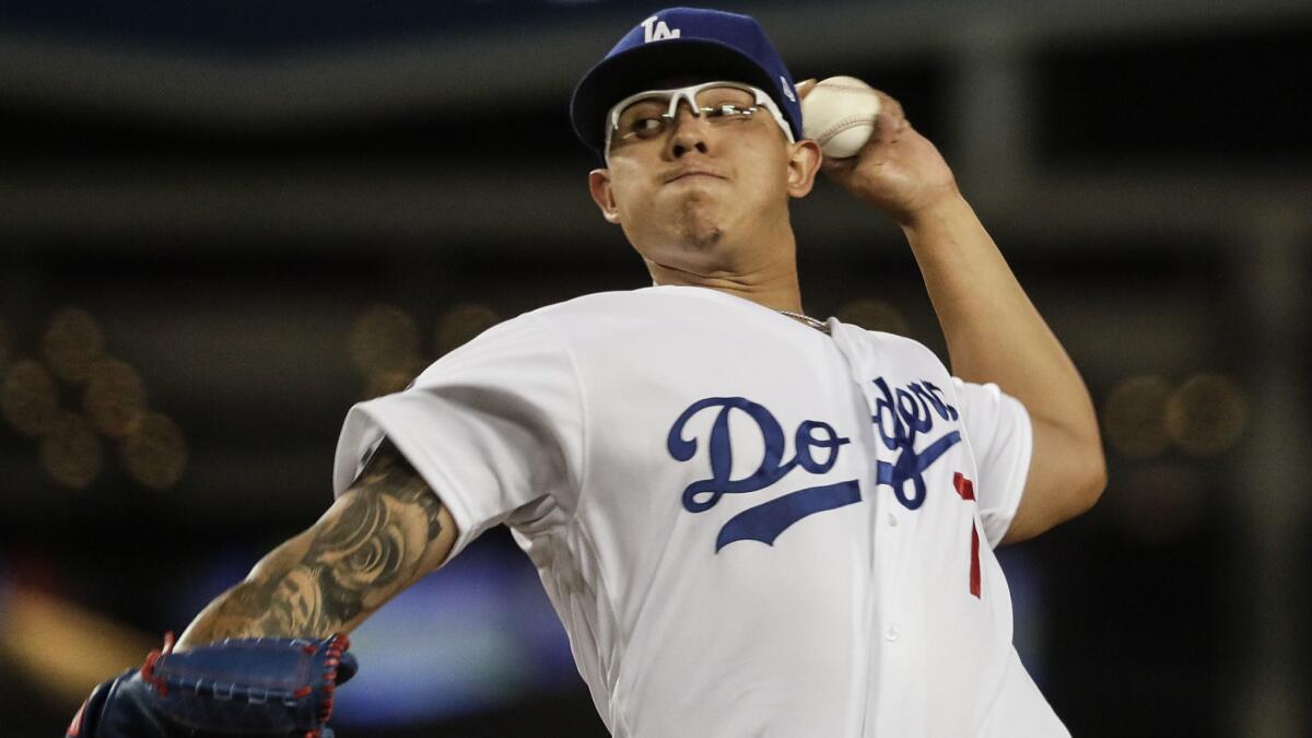 Dodgers starter Julio Urías pitches against the San Francisco Giants in the fourth inning at Dodger Stadium on Monday.