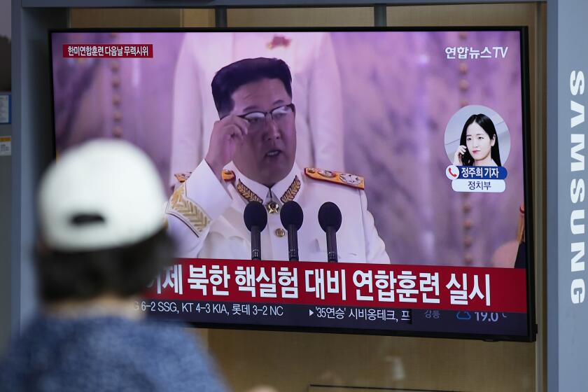 A woman watches a TV screen showing a news program reporting about North Korea's missile launch with a file footage of North Korean leader Kim Jong Un, at a train station in Seoul, South Korea, Sunday, June 5, 2022. North Korea test-fired a salvo of multiple short-range ballistic missiles toward the sea on Sunday, South Korea's military said, extending a provocative streak in weapons demonstrations this year that U.S. and South Korean officials say may culminate with a nuclear test explosion. (AP Photo/Lee Jin-man)