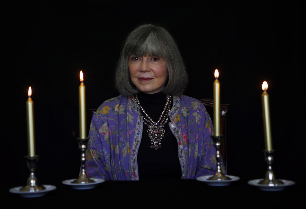 A woman surrounded by candles.