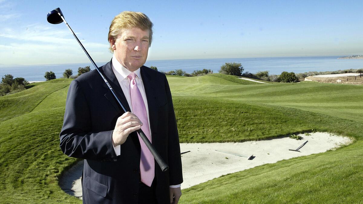 Donald Trump poses next to the 11th hole at Trump National Golf Club in Rancho Palos Verdes in 2005.