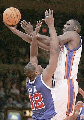New York's Tim Thomas shoots over Elton Brand during the second quarter.