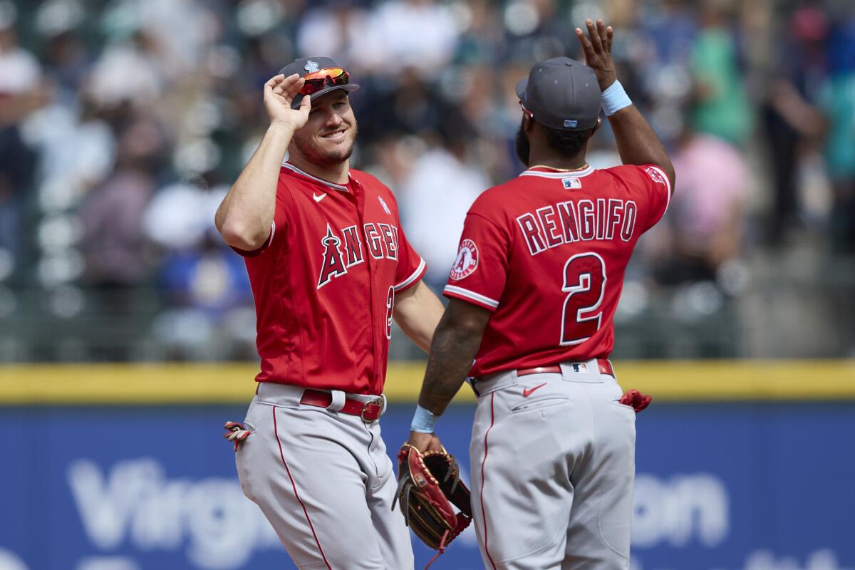 Angels' \Mike Trout and Luis Rengifo celebrate a win over the Seattle Mariners.