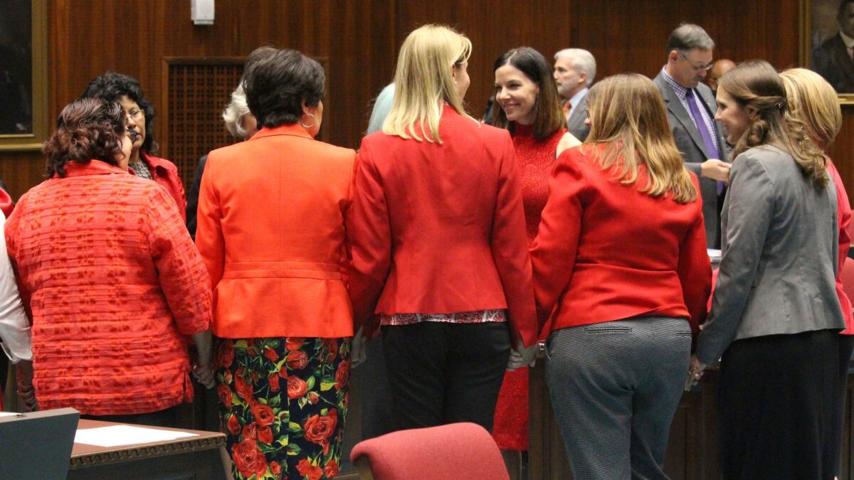 Members of the Arizona House, from Republican and Democratic parties, hold hands to express support for Rep. Michelle Ugenti-Rita as the House prepares to vote on Feb. 1, 2018.