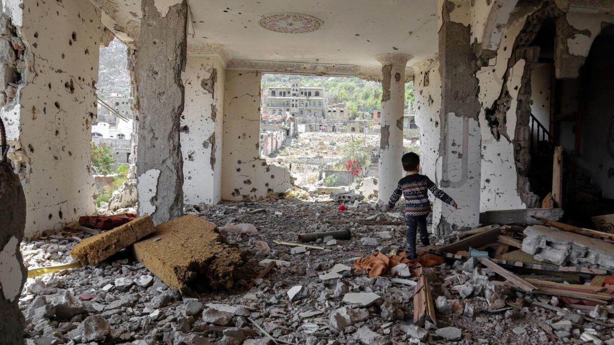 A child walking in the rubble of a building that was destroyed in an air strike in the southern Yemeni city of Taez on March 18.