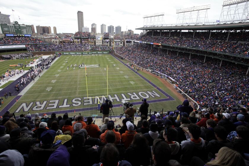 FILE - Illinois plays against Northwestern during the first quarter of an NCAA college football game at Wrigley Field, home of the Chicago Cubs baseball team, in Chicago, on Nov. 20, 2010. Wrigley Field will host a college football game for the third time since 2010 when Iowa plays Northwestern next season on Nov. 4, 2023, Northwestern and the Chicago Cubs announced Tuesday, Feb. 7, 2023. (AP Photo/Nam Y. Huh, File)