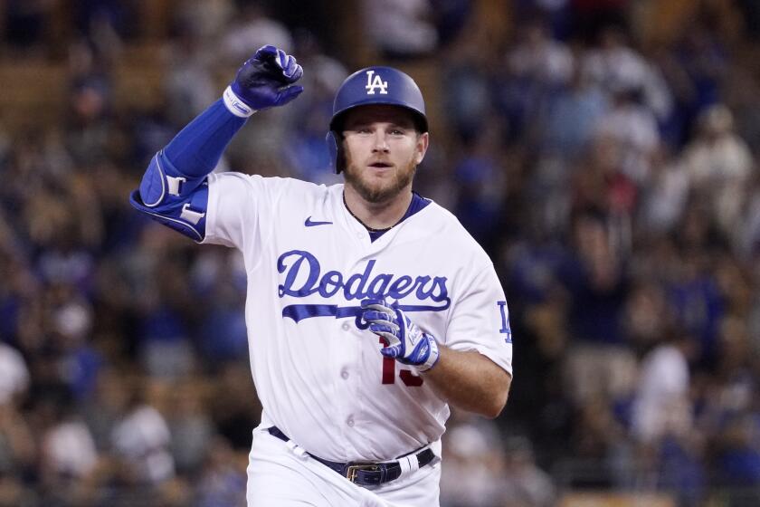 Los Angeles Dodgers' Max Muncy gestures as he heads to third after hitting a solo home run during the sixth inning of a baseball game against the San Francisco Giants Tuesday, Sept. 6, 2022, in Los Angeles. (AP Photo/Mark J. Terrill)