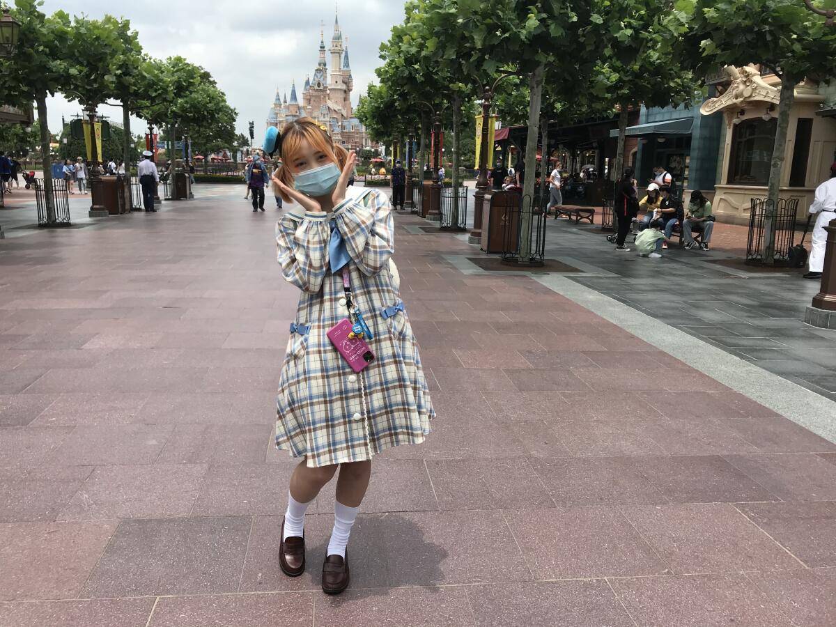 A young visitor expresses glee at Shanghai Disneyland, which is allowing in only 30% of its 80,000-visitor capacity per day.