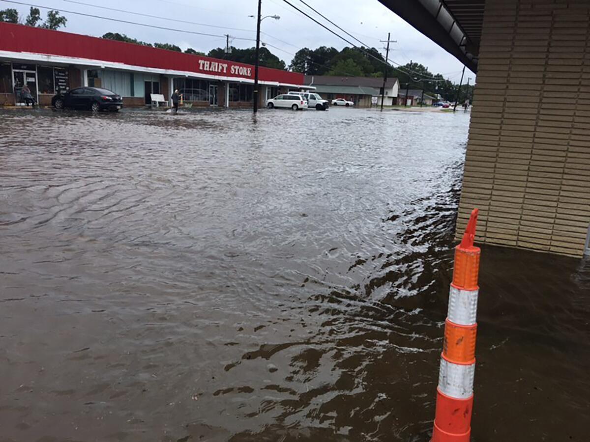In this photo provided by Pastor Bryant May, rain water covered Bierdeman Road in Pearl, Miss., Wednesday, Ag. 24, 2022. Several buildings on the street were flooded, including an outlet store and a church. (Pastor Bryant May via AP)