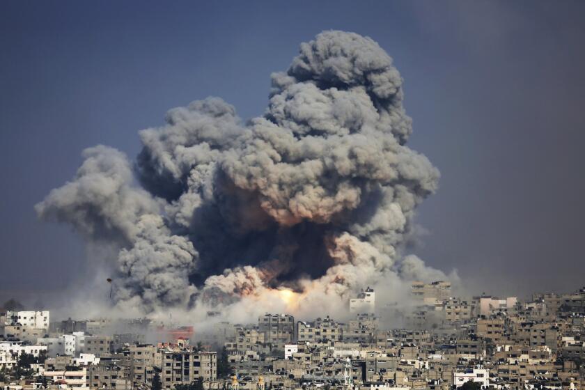 In this July 2014 file photo, smoke and fire from an Israeli strike rise over Gaza City.