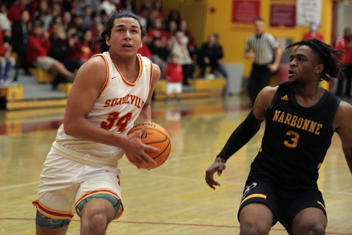 Mt. Carmel's Zach Rose drives against Narbonne's Andrew Gill in a SoCal Div III regional playoff game Thursday night