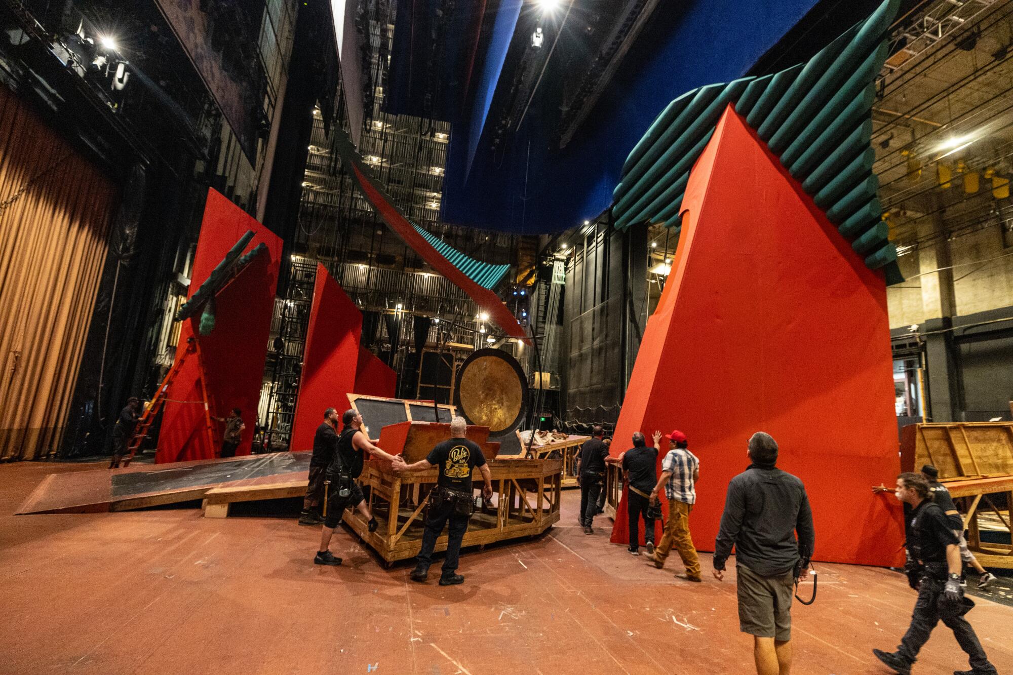 Workers move giant "Turandot" set pieces backstage for the second act during a rehearsal.