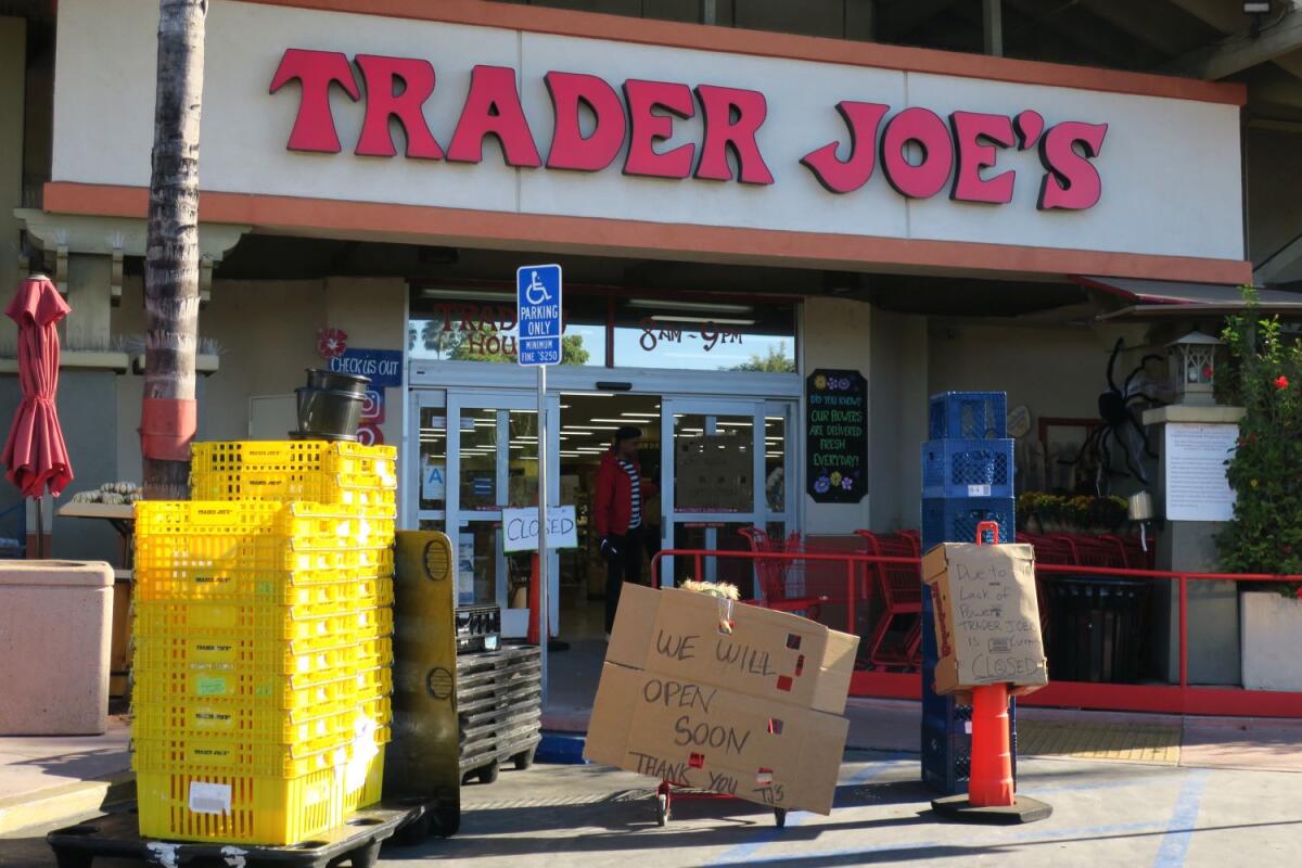 A sign outside the Trader Joe's in La Cañada Thursday morning announces that, due to an earlier power outage, the store could not open at its usual hour. An employee explained the refrigeration system had to be checked before the store could reopen.