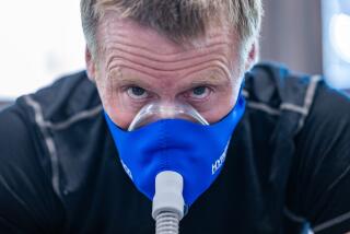 Truckee, CA - April 18: Graham Cooper exercises a training mask connected to an altitude generator for low oxygen training to prepare for an ascent of Mt. Everest on Thursday, April 18, 2024 in Truckee, CA. (Brian van der Brug / Los Angeles Times)