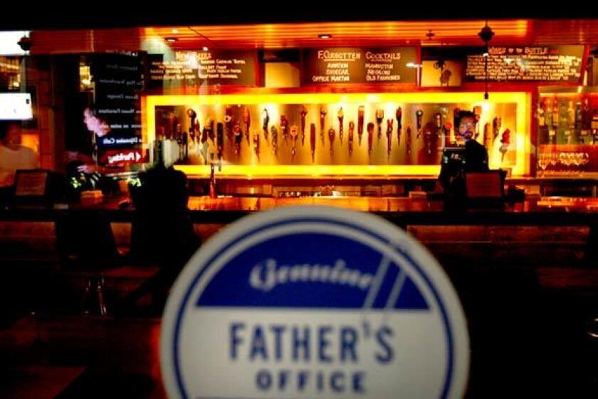 Vintage beer taps are mounted behind the bar at the new Fathers Office in Los Angeles. The Helm Bakery location boasts a top-notch beer list, plus wine, spirits and sophisticated pub grub.