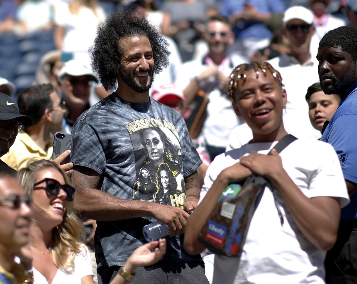 Colin Kaepernick reacts after watching Naomi Osaka of Japan defeat Magda Linette of Poland during the second round of the U.S. Open tennis championships on Thursday, Aug. 29, 2019, in New York.