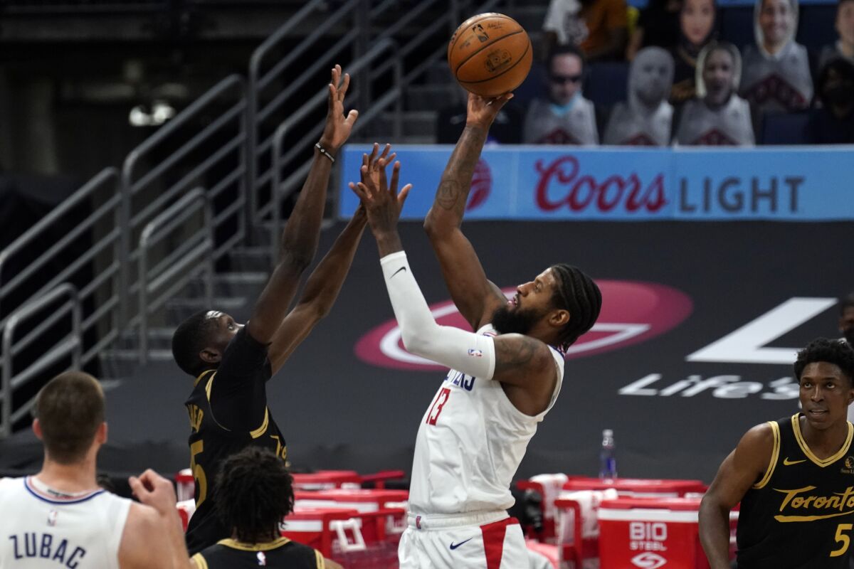 Los Angeles Clippers guard Paul George (13) shoots over Toronto Raptors forward Chris Boucher (25) during the second half of an NBA basketball game Tuesday, May 11, 2021, in Tampa, Fla. (AP Photo/Chris O'Meara)