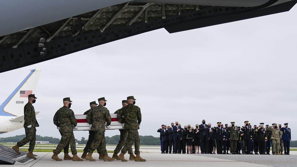 Troops carry a flag-covered case at Dover Air Force Base.