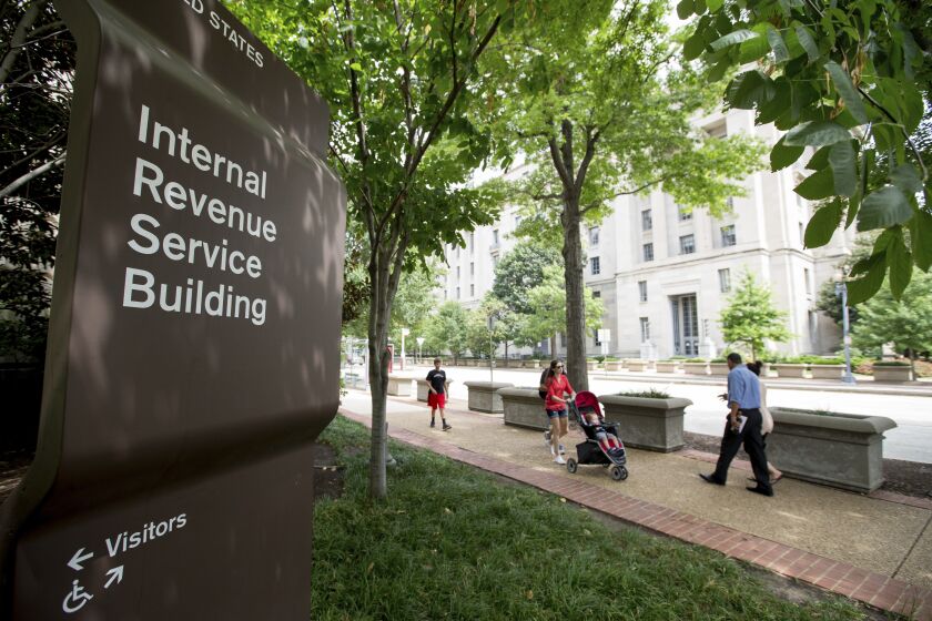 FILE - This Aug. 19, 2015, file photo, shows the Internal Revenue Service Building in Washington. The tax overhaul bill has yet to be passed at this point. But if it does, those changes will take effect in 2018. The IRS said that it is closely monitoring the bill and expects to issue initial withholding guidance in January, which would allow taxpayers to begin seeing the benefits of the change as early as February. (AP Photo/Andrew Harnik, File)