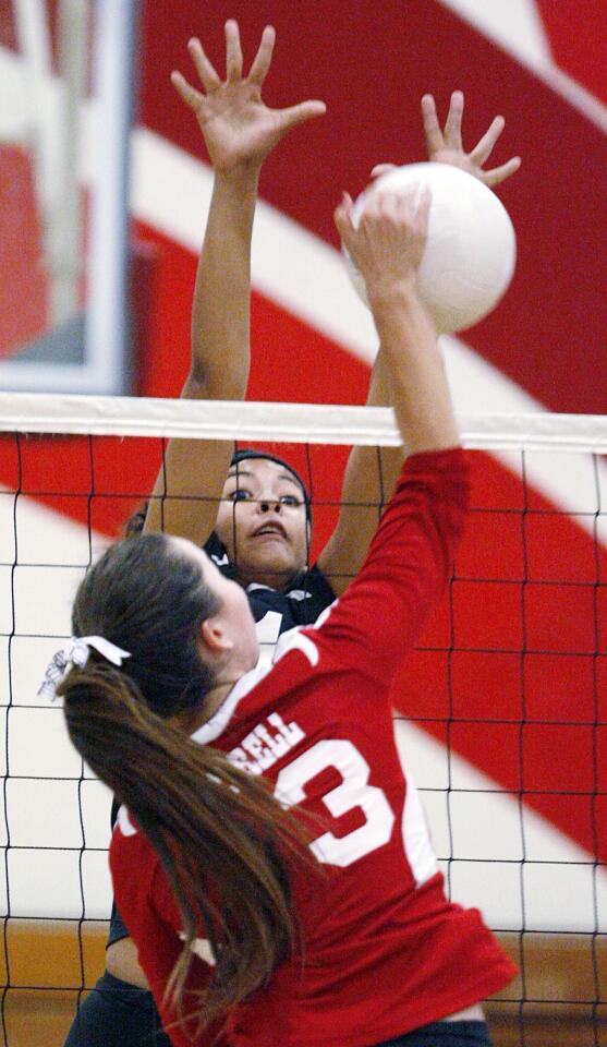 Pasadena's Bayley Neubauer stretches to block Burroughs' Caitlin Cottrell in a Pacific League girls volleyball match at Pasadena High School on Tuesday, October 2, 2012.