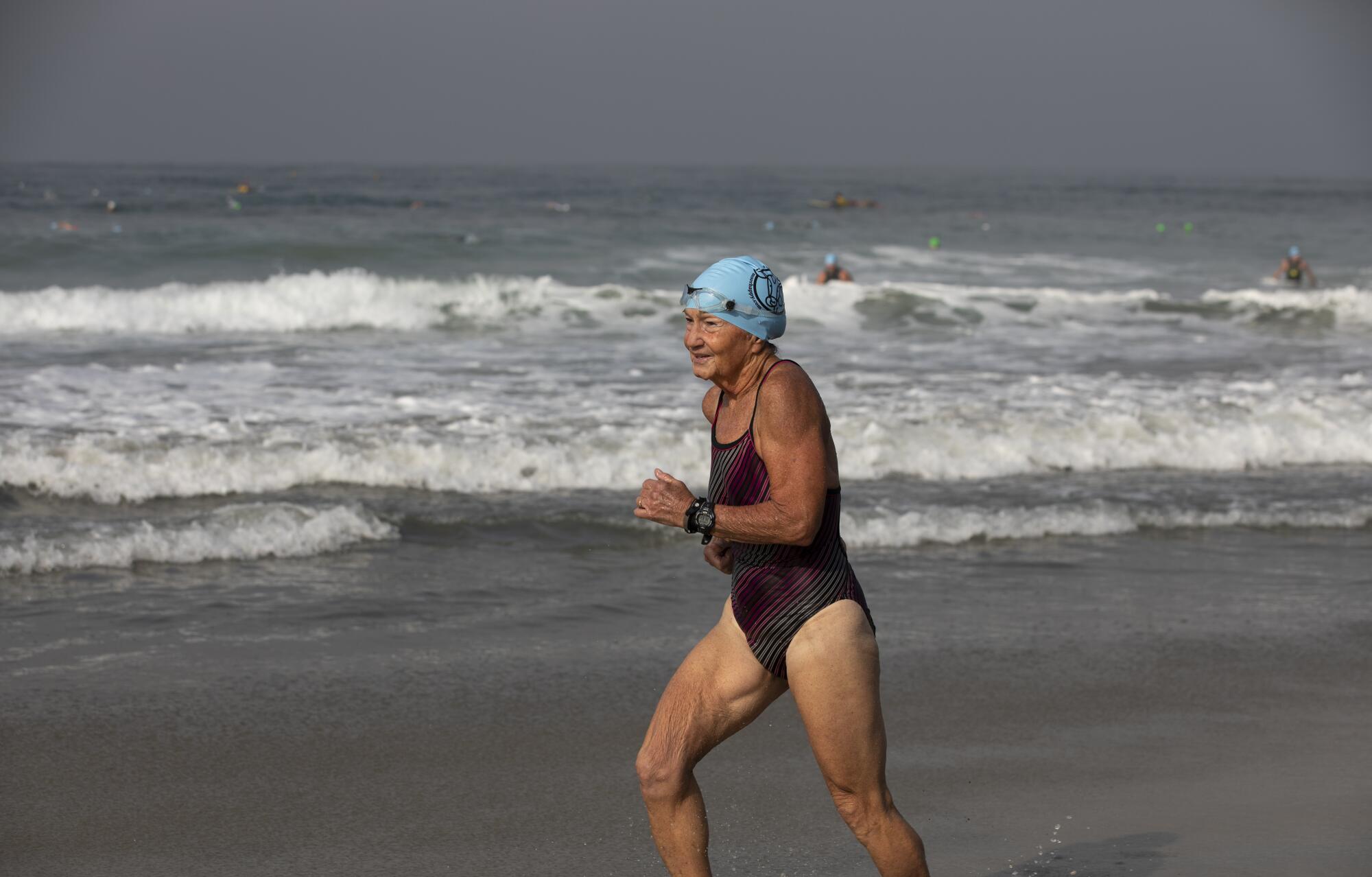 Janet Buchanan, 70, of Encinitas, runs to the finish line.